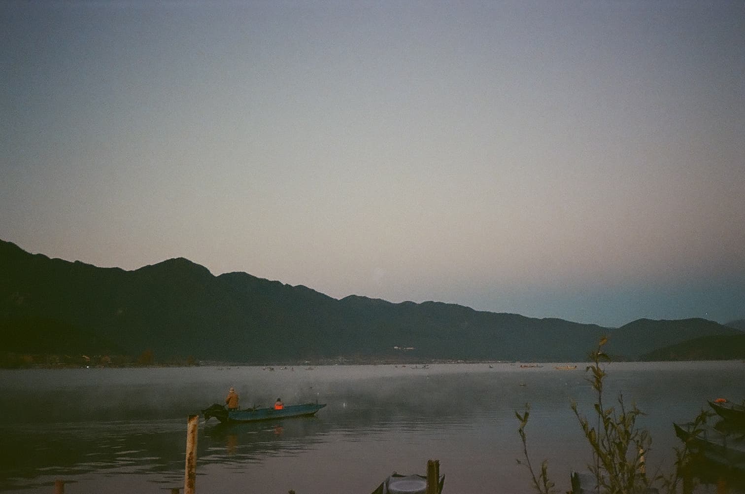 Lugu Lake at sunrise, mist over the water, Yunnan